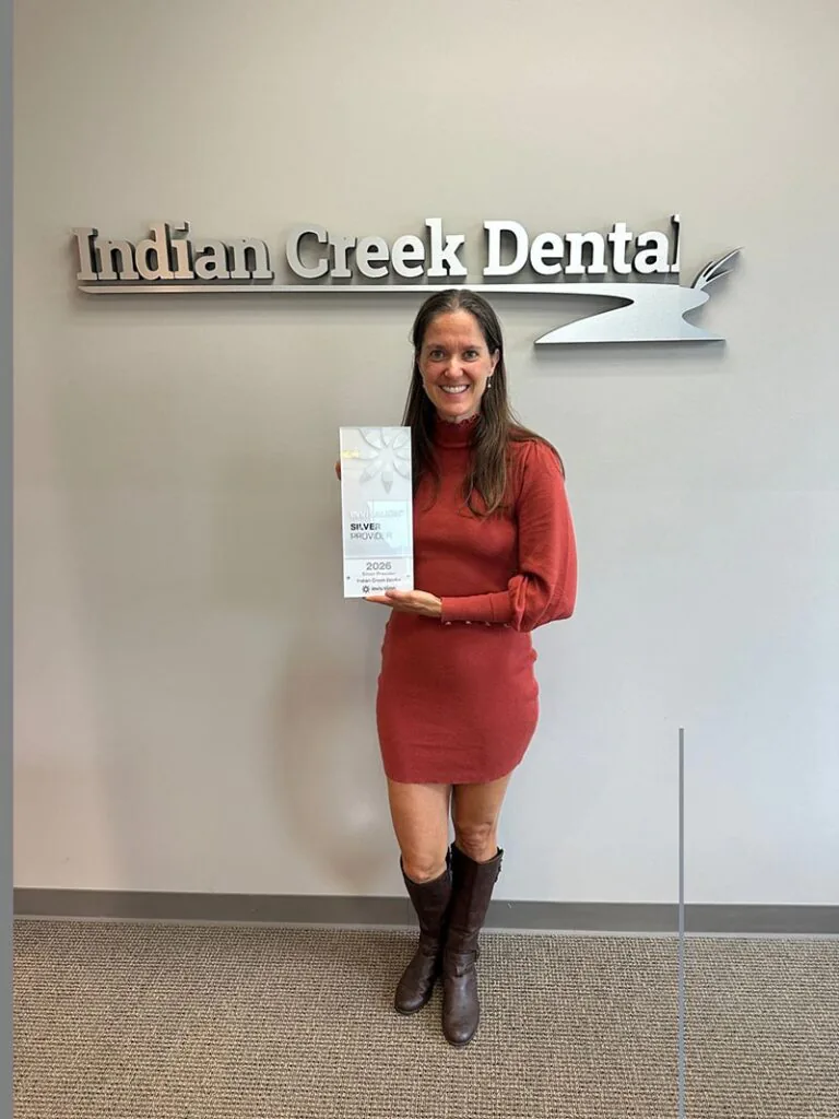 Dr. Marcy Walker holding Invisalign clear aligners